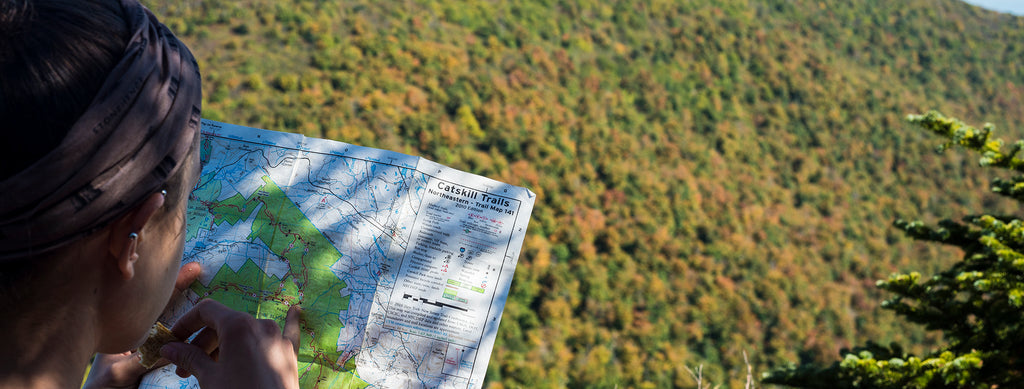a hiker examines a Catskills map