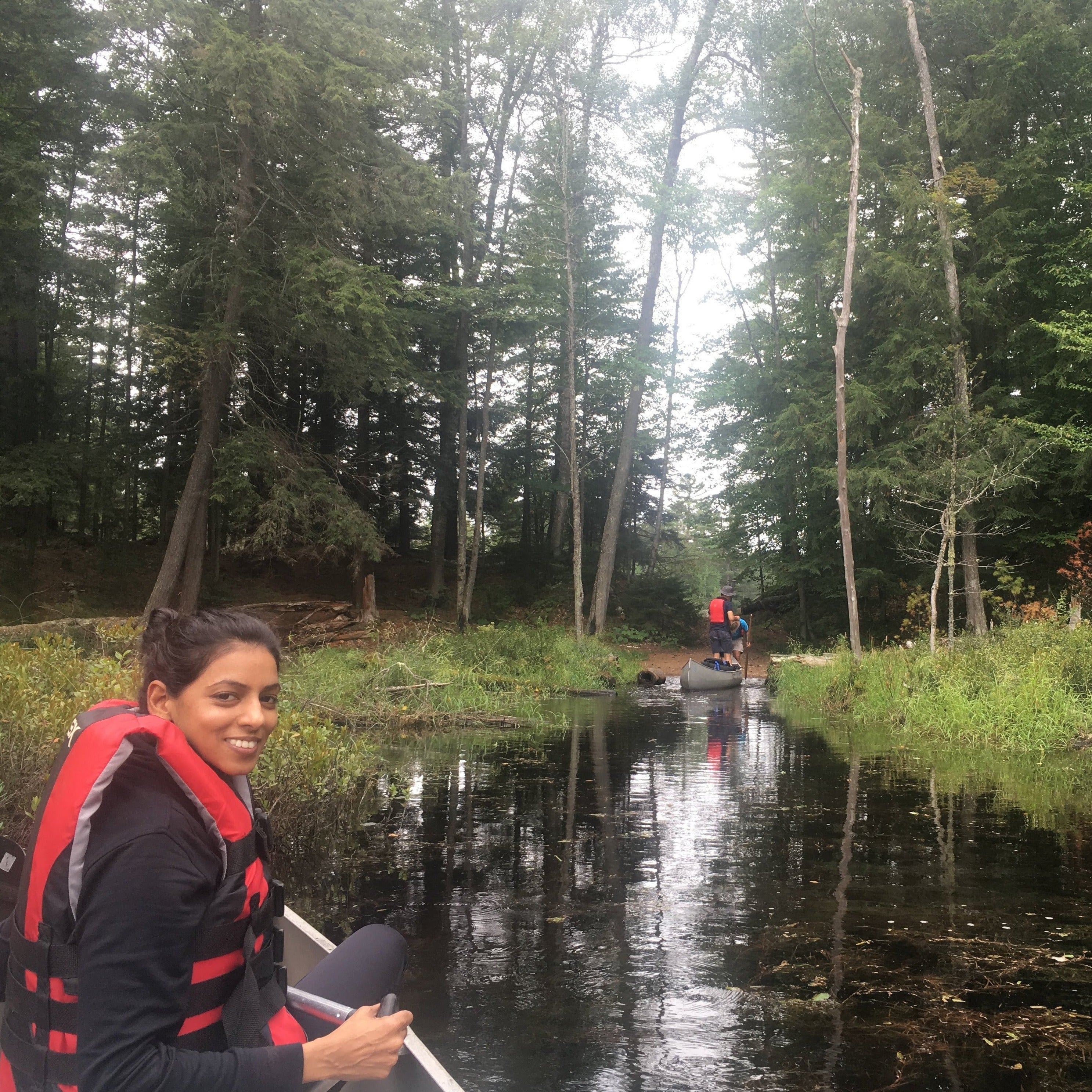 a woman in a canoe poses before a putin