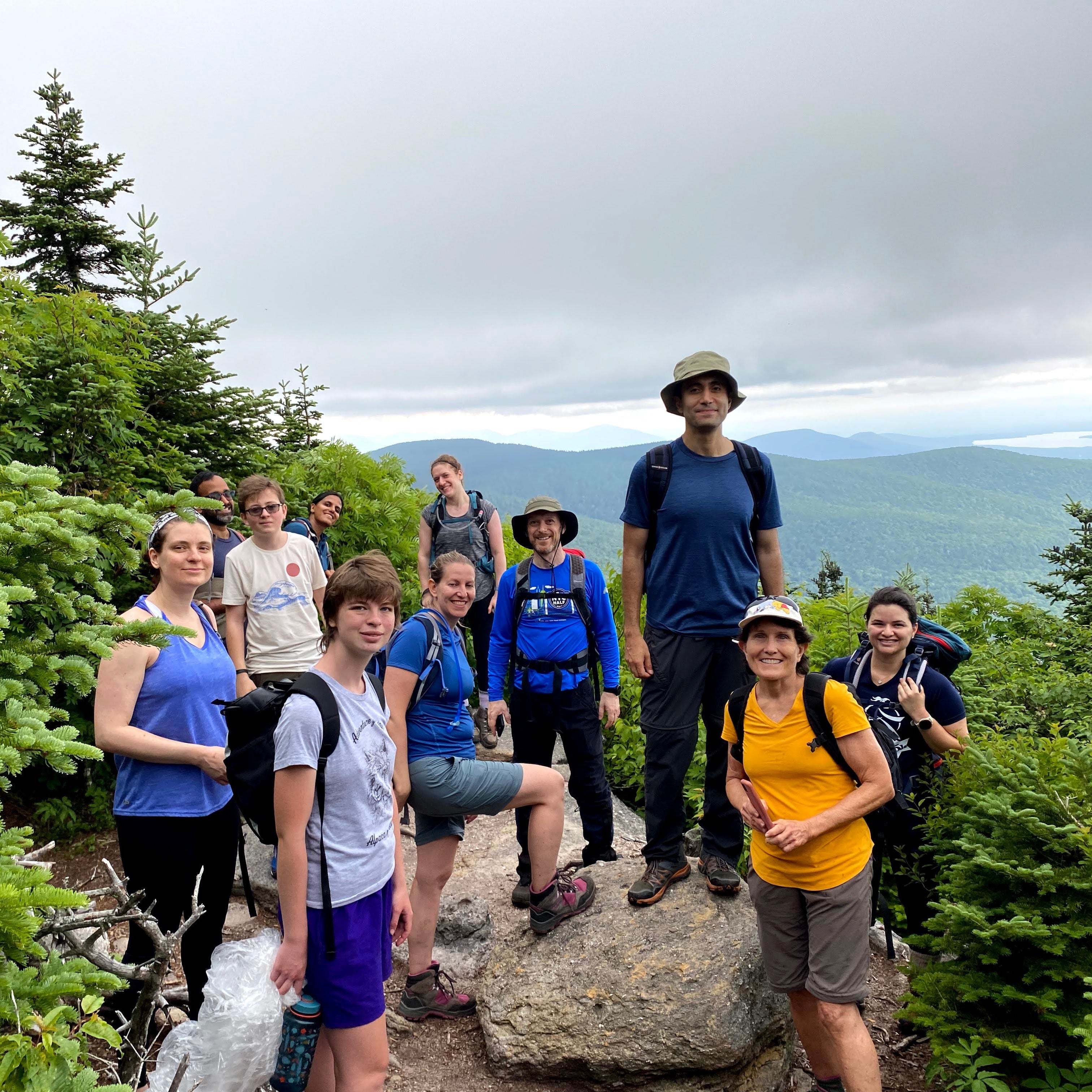 a group of hikers pose at the summit of peekamoose mountain