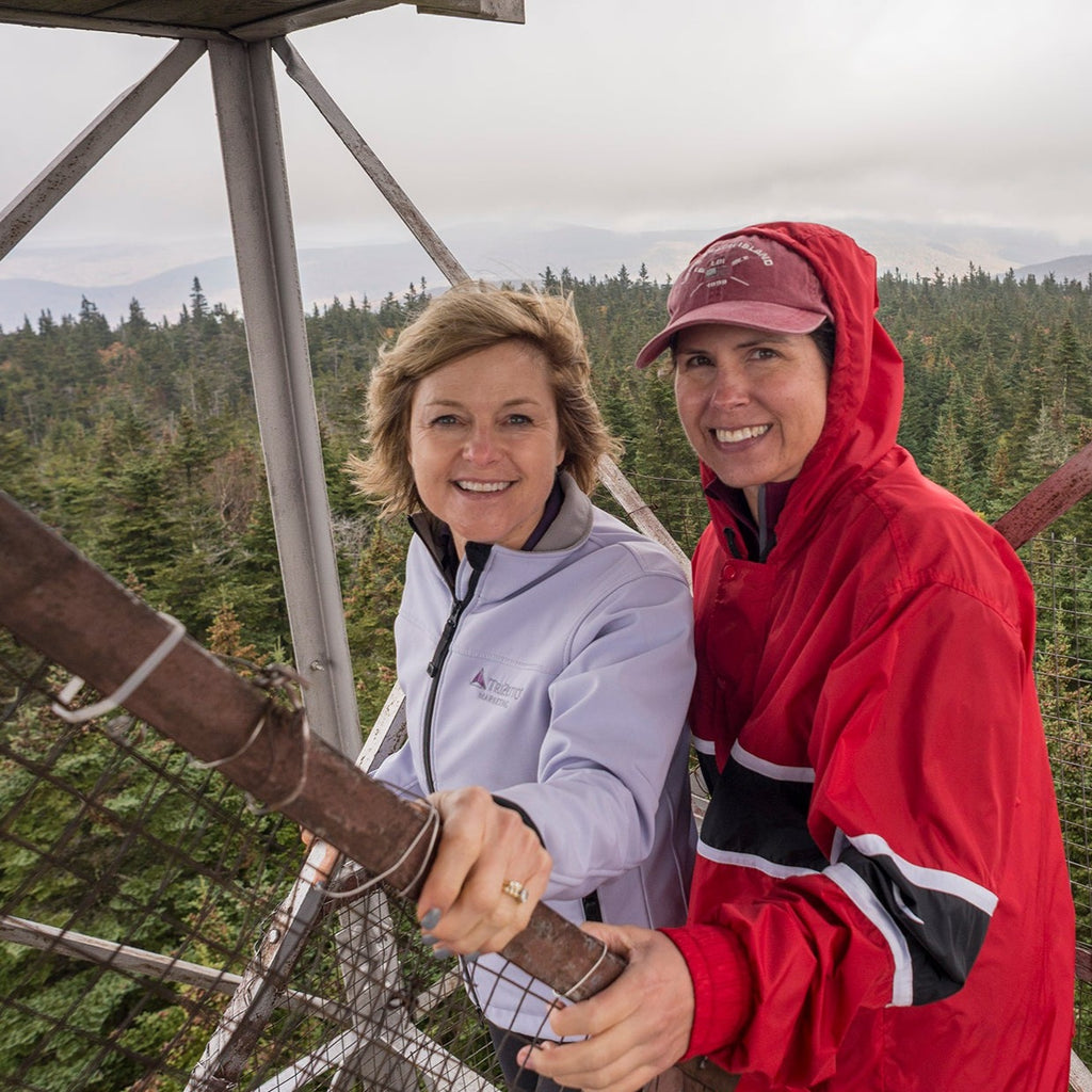 two people post at the top of the fire tower on balsam lake mountain