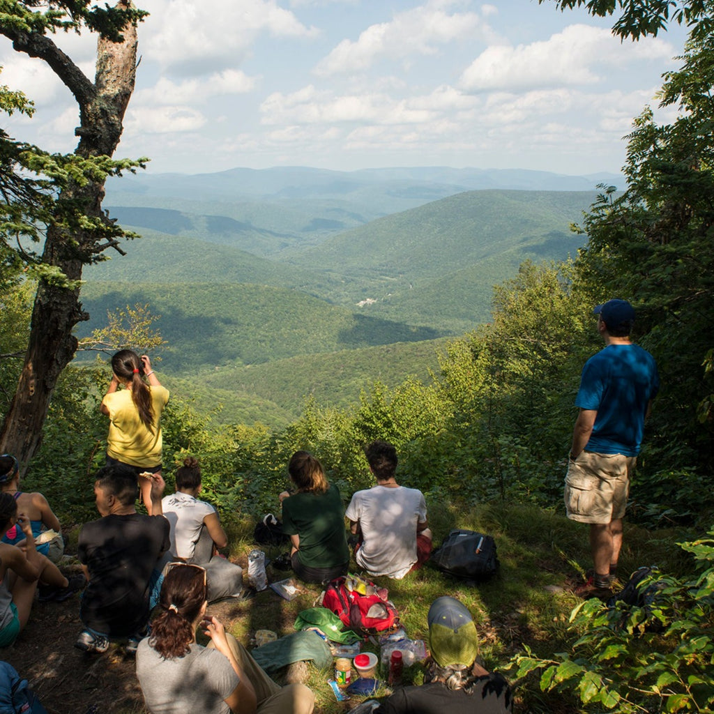 a group of hikers eating lunch at a summit view on Balsam Mountain in the Catskills
